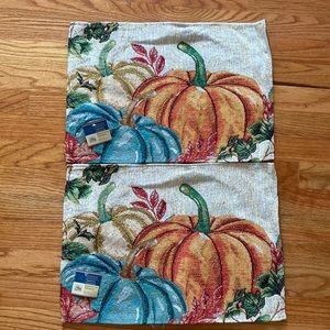 2 tapestry placemats with pumpkins.